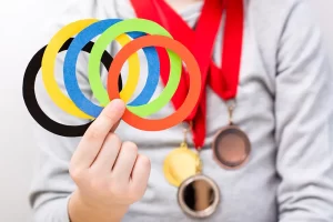 child holding Olympic rings